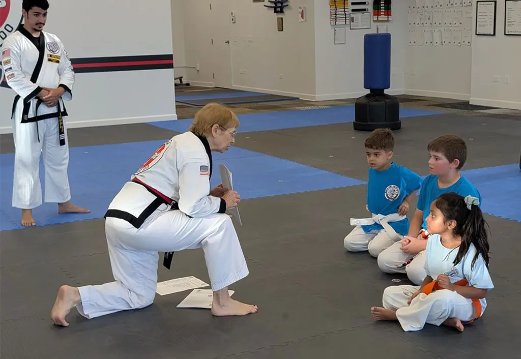 ROMA Tang Soo Do instructor teaching children personal safety basics during a beginner martial arts class.
