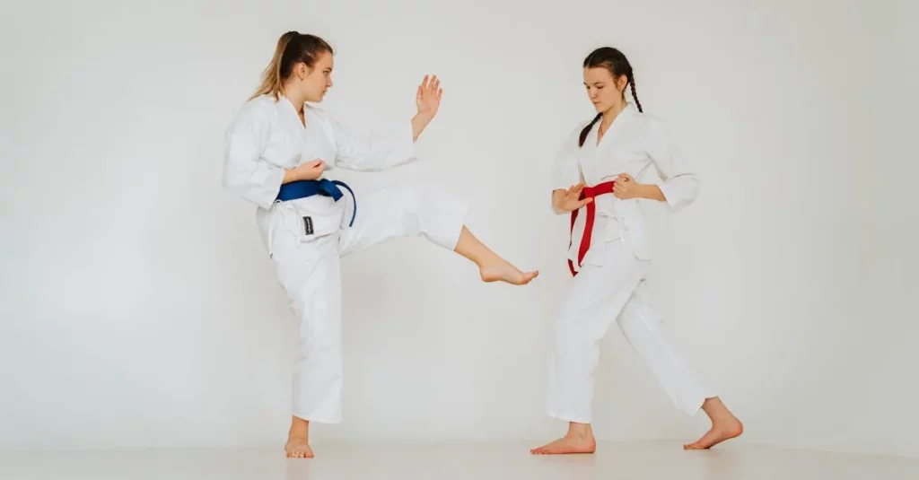 Two martial arts students practicing controlled kicks while learning beginner self defense tips.